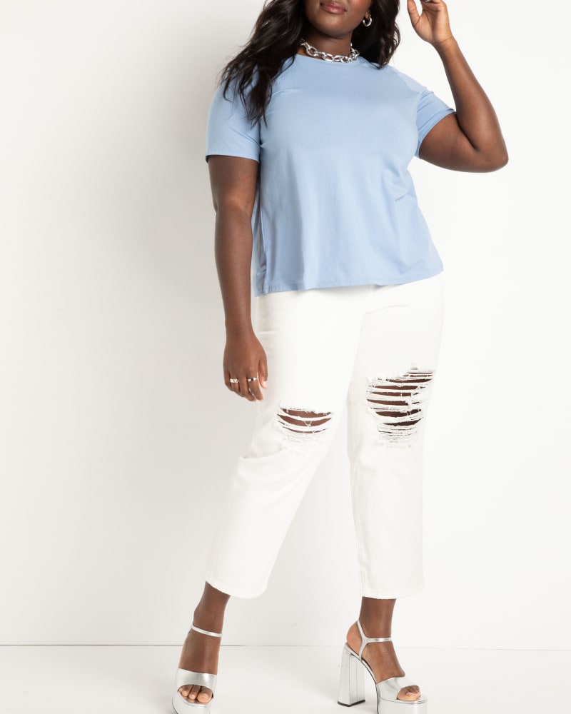 Front of a model wearing a size 18 Distressed Skinny Jean in White Denim by ELOQUII. | dia_product_style_image_id:272796